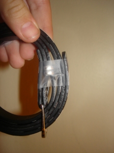 Wrap a piece of clear tape around the end of the belt...
